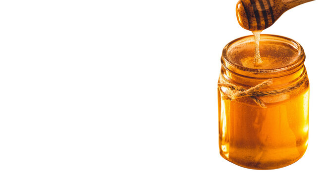 Fresh organic honey in glass jar with wooden dipper transparent png