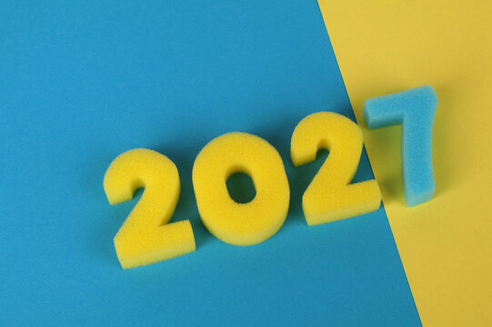 Colorful foam numbers spelling the year 2027 on a diagonal blue and yellow background