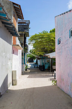 Narrow sandy village street in a tropical island in Maldives
