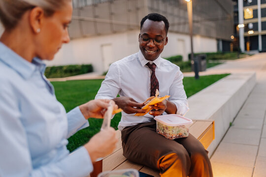 Diverse business colleagues having lunch break outdoors