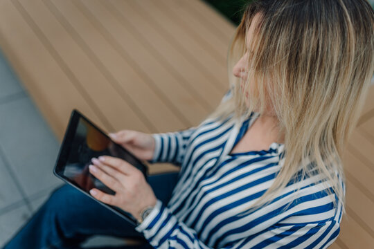Woman using digital tablet for online communication
