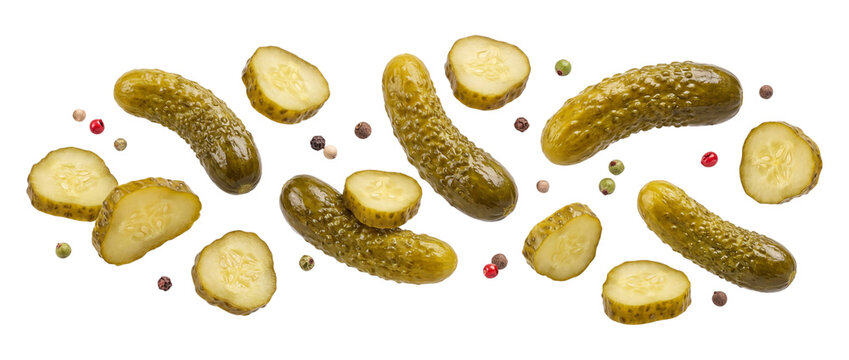 Falling pickles and peppercorns isolated on transparent background