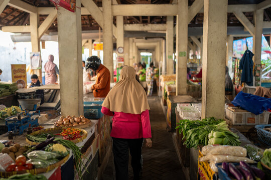 Woman shopping for fresh produce at traditional market