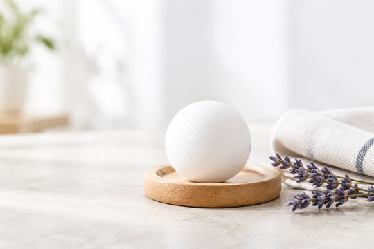 Camphor ball on wooden coaster with cotton cloth and dried lavender