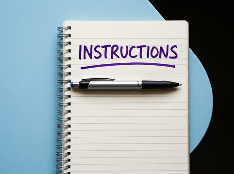 Open notebook with pen displaying text instructions suitable for educational or business content symbolizing guidance rules and direction