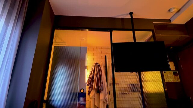 A firstperson perspective showing feet resting on a white bed in a stylish boutique hotel room in Madrid, Spain. Perfect for travel vlogs and wellness content.