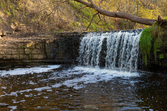 At the Sablinka waterfall on a sunny October morning. Leningrad oblast, Russia
