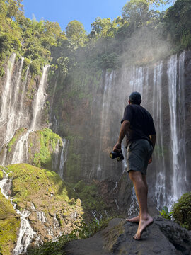 Man exploring tumpak sewu waterfall in indonesia