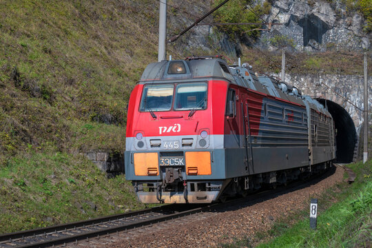 IRKUTSK REGION, RUSSIA - SEPTEMBER 07, 2025: Russian electric locomotive 3ES5K Ermak left the Kirkidai railway tunnel. Circum-Baikal Railway