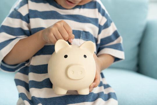 Save money. children putting coin for saving. wealth, Finance, insurance, investment, education, future, plan life, learn, banking, family, health, health and accident insurance.