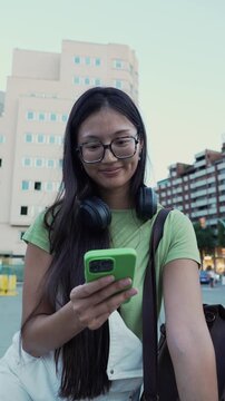 Young asian woman using smartphone on bicycle