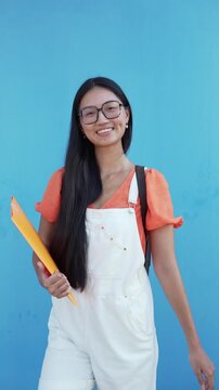Young asian student posing with backpack