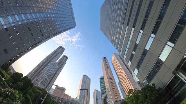 TOKYO, JAPAN - JULY 2026 : Skyscrapers and high-rise office buildings in Nishi-Shinjuku business district at sunset. Japanese corporate business, financial hub and urban technology concept.