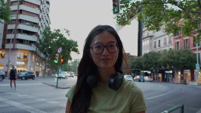 Young asian woman smiling at the camera in the city