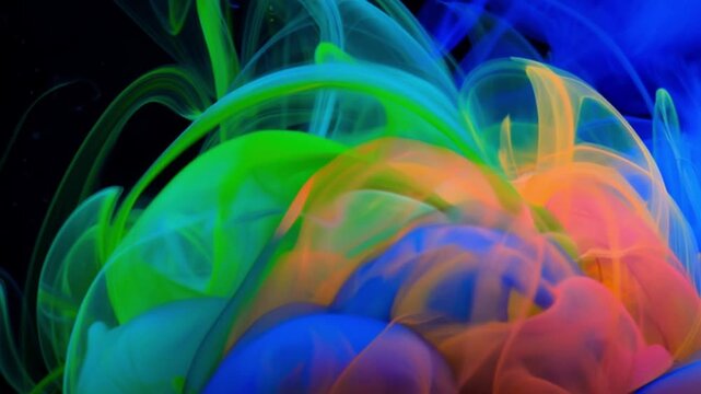 Swirling colorful ink and smoke on dark background, 4K video

