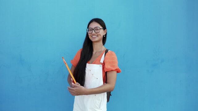 Young asian student woman smiling at camera, back to school concept