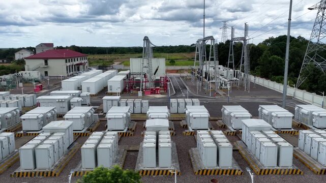 rows of white transformers in outdoor power substation