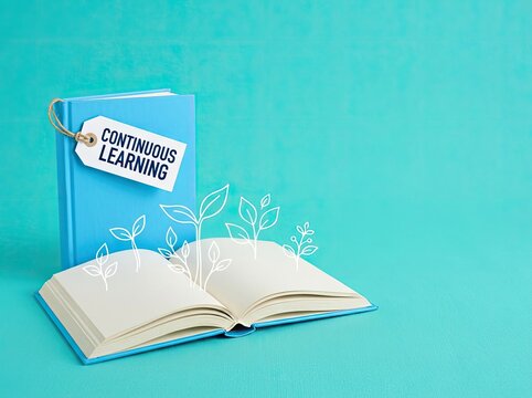 Blue book with tag continuous learning and open notebook with plant doodles ideal for education content symbolizing growth through knowledge