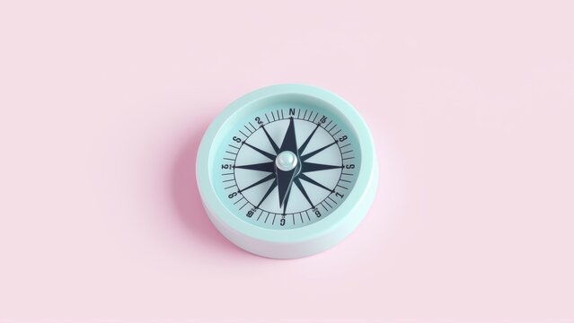 Pale pink backdrop features round compass. Needle points north. Simple design, navigational tool, flat lay presentation.