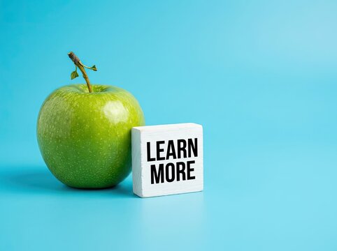 Green apple with a learn more block suitable for educational health content representing curiosity knowledge acquisition and wellness tips