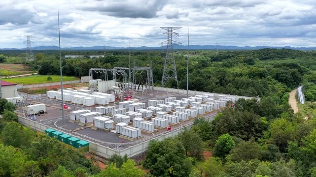 outdoor high voltage power substation surrounded by lush green vegetation