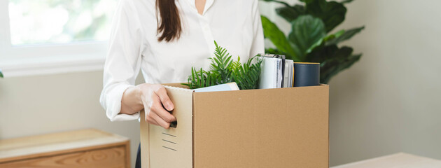 Fototapeta na wymiar unemployed concept, employee clear her stuff at office to move out after get layoff from company in recession.
