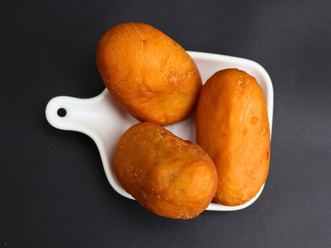Luti gendang sit on a white plate.  Appealing to food lovers and casual eaters