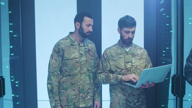 Soldiers inspect shutdown, Caucasian troops in quiet corridor, Dim corridor hosts soldiers overseeing system shutdown