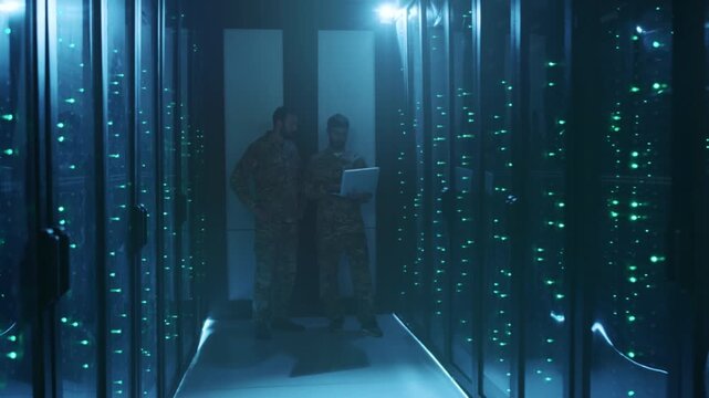Army soldiers systematically patrol and verify server racks during routine security checks with portable devices