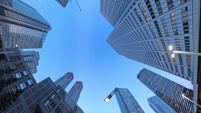 TOKYO, JAPAN - JUL 2026 : Directly below view of modern skyscrapers and office towers in Shinjuku business district at sunset. Japanese corporate business, financial hub and urban technology concept.