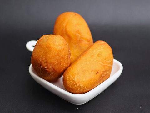 Luti gendang sit on a white plate.  Appealing to food lovers and casual eaters