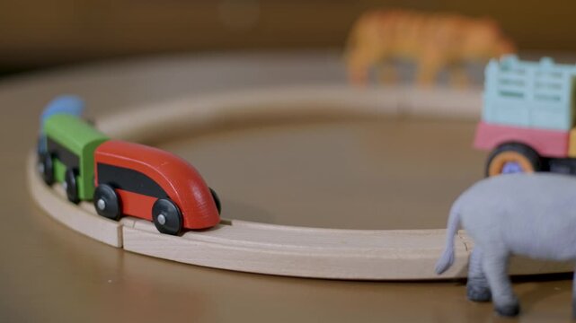 Toy Train And Elephant Figurine On Wooden Train Track