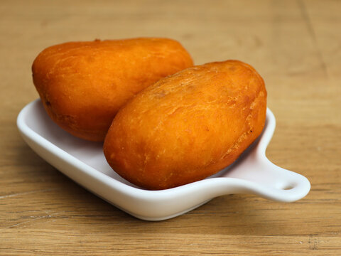 Luti gendang sit on a white plate.  Appealing to food lovers and casual eaters