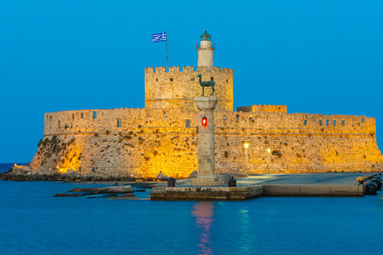 Rhodes Greece  Two deer at Mandraki harbor, Rhodes old town with view at Holy Metropolis of Rhodes church