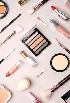 Vertical flat-lay beauty products,cosmetic items set, lipsticks, brushes and powders top view.Makeup tools collection.