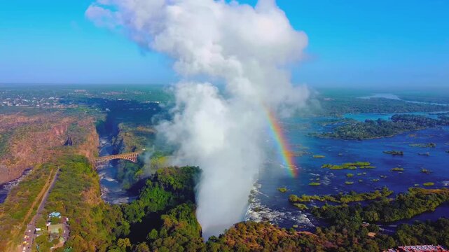Victoria falls drone shot with amazing rainbow on clear blue sky