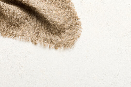 Old burlap fabric napkin, sackcloth on table background. top view with copy space