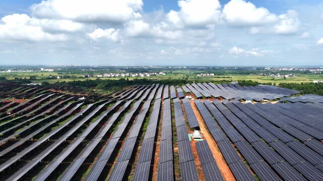 Rows of solar panels under blue sky and white clouds