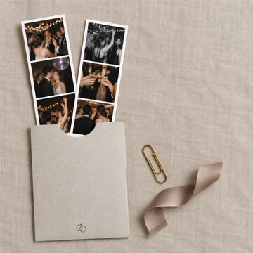 Blank wedding photo booth strip sleeve mockup with ribbon on linen background