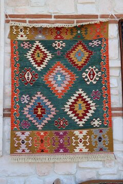 A hand-woven kilim featuring traditional Turkish motifs. The kilim was woven in the villages of the Konya plain.