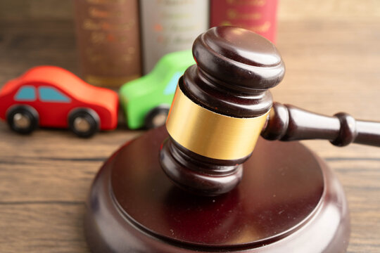 Car accident lawsuit and insurance, Judge hammer with car model.