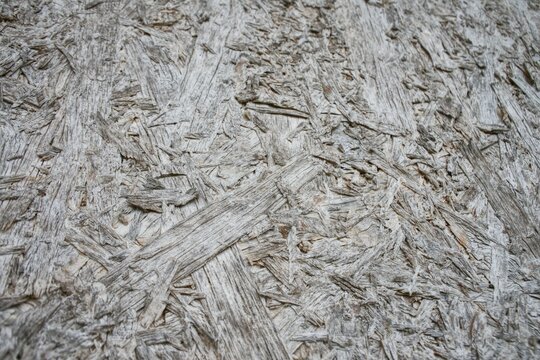 Close up view of weathered old OSB wood board texture background