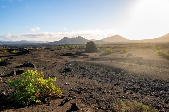 Large round volcanic stone Bomba volc&aacute;nica Gude, volcanic landscape with lava fields, Parque Natural de Los Volcanes, Lanzarote, Canary Islands, Spain