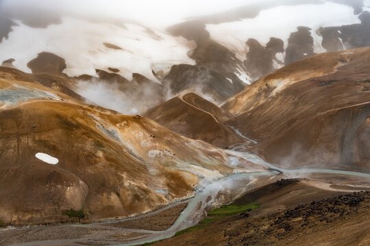 Bridge and steaming streams between colourful rhyolite mountains and snowfields, Hveradalir geothermal area, Kerlingarfj&ouml;ll, Icelandic Highlands, Iceland