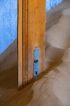 Interior view, door and house full of sand, former diamond mining town, Namib Desert, Kolmanskop, Karas, Namibia