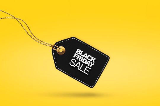 Black price tag on yellow background with copy space for Black Friday sale discount promotion advertising and special offers