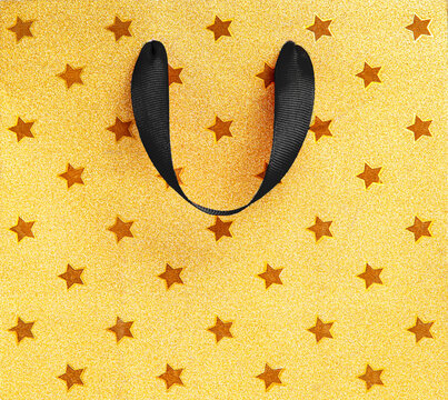 Yellow and black shopping background with bag handles and copy space for Black Friday sale discounts promotions and advertising