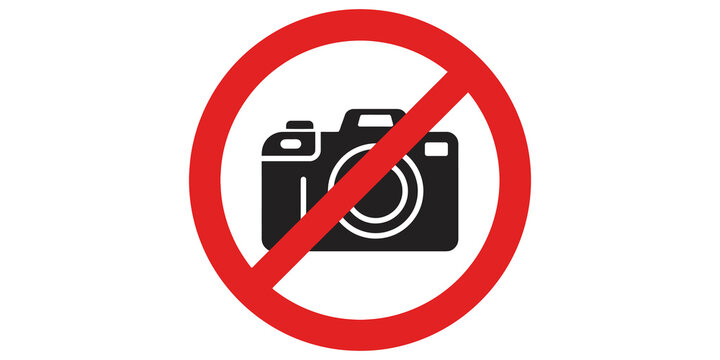 Red prohibition sign over camera icon forbidding photography in area.