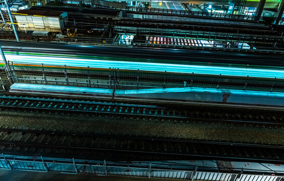 High Speed Train Passing Railway Tracks in Tokyo at Night