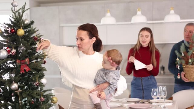 Woman decorating Christmas tree, family preparing for Christmas. Woman decorating Christmas tree. High quality 4k footage